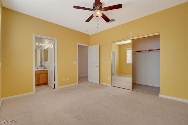 unfurnished bedroom with connected bathroom, light carpet, a closet, and ceiling fan