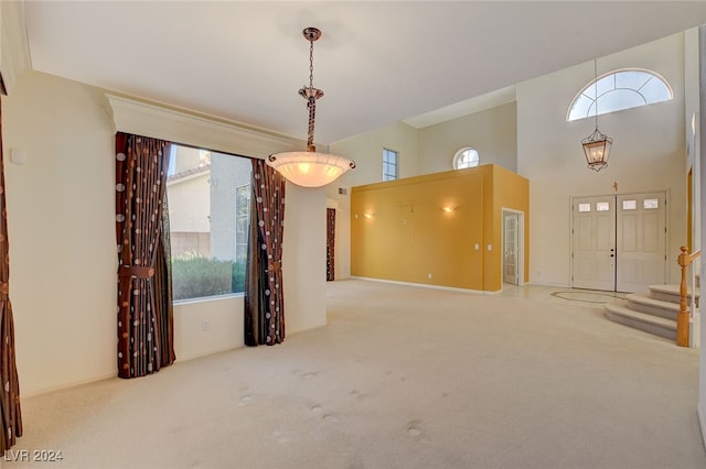 interior space featuring carpet flooring and a high ceiling