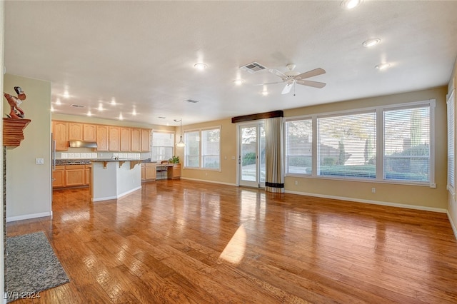 unfurnished living room featuring light hardwood / wood-style floors and ceiling fan