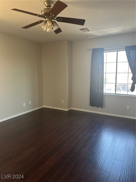 spare room with dark hardwood / wood-style floors and ceiling fan