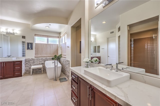 bathroom featuring vanity, a bathtub, and tile patterned floors