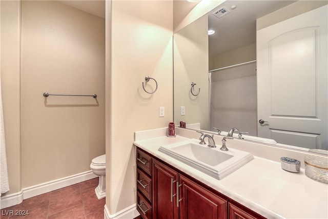 bathroom with vanity, toilet, and tile patterned flooring