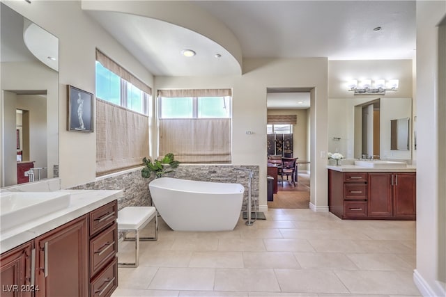 bathroom featuring vanity, tile patterned flooring, and a bathing tub