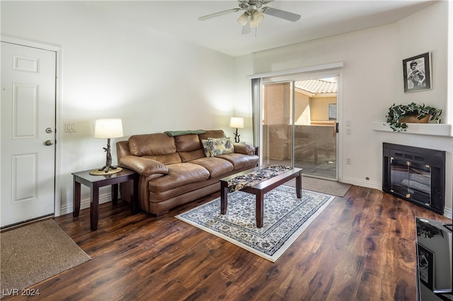 living room with dark hardwood / wood-style flooring and ceiling fan