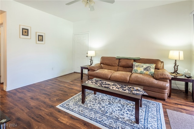 living room with dark wood-type flooring and ceiling fan