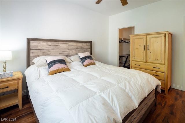 bedroom featuring a spacious closet, dark hardwood / wood-style floors, and ceiling fan