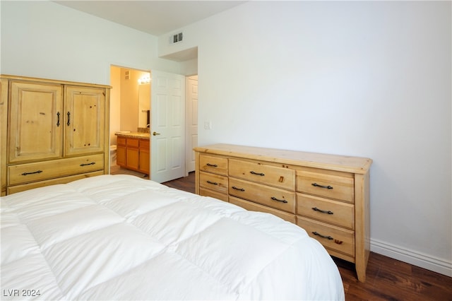 bedroom with dark hardwood / wood-style floors