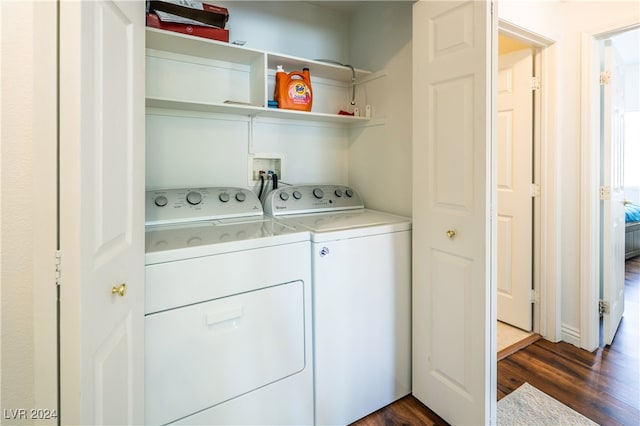 laundry room featuring washer and dryer and dark wood-type flooring