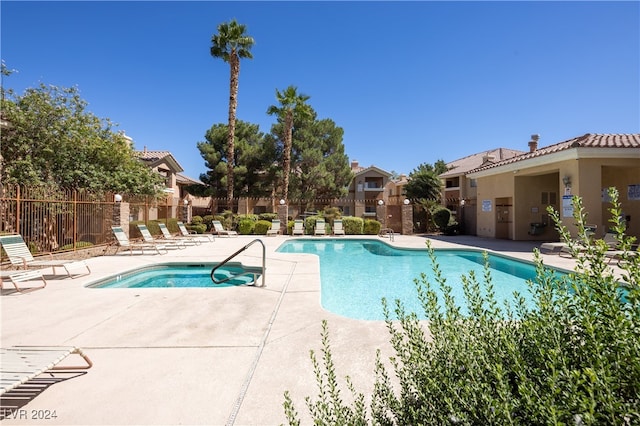 view of pool featuring a hot tub and a patio