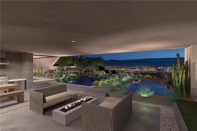 view of patio with a mountain view and an outdoor living space with a fire pit