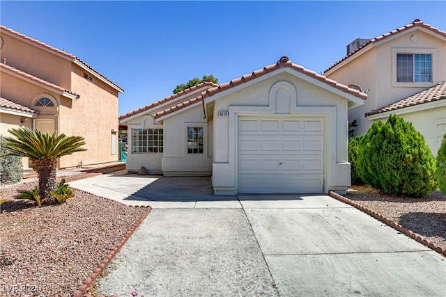 mediterranean / spanish house with a garage