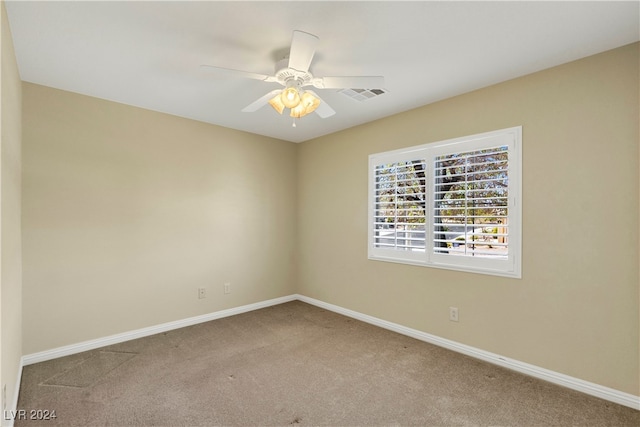 empty room featuring carpet floors and ceiling fan