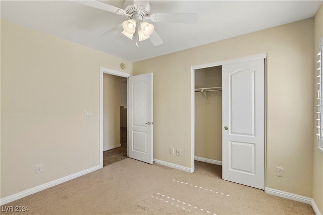 unfurnished bedroom featuring ceiling fan, a closet, and light carpet