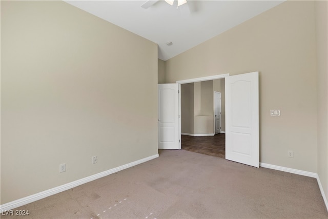 unfurnished bedroom featuring vaulted ceiling, ceiling fan, and carpet floors