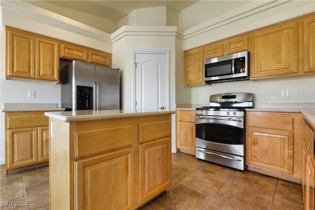 kitchen featuring stainless steel appliances, tile patterned flooring, and a kitchen island