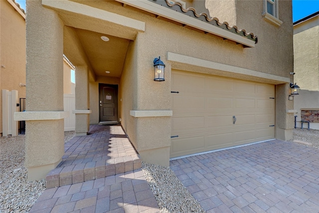 doorway to property with a garage