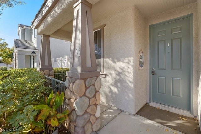 doorway to property with a porch