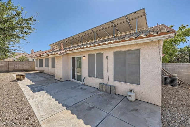 rear view of property featuring central AC unit and a patio