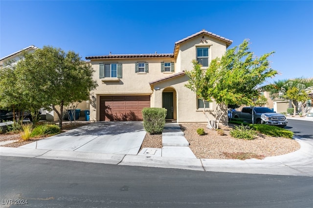 mediterranean / spanish-style house featuring a garage