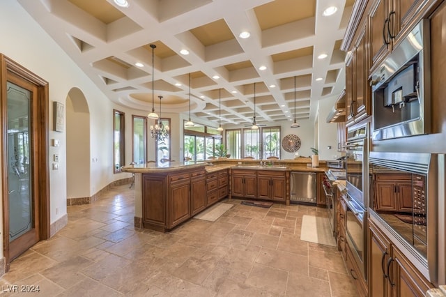 kitchen featuring pendant lighting, coffered ceiling, appliances with stainless steel finishes, beamed ceiling, and kitchen peninsula