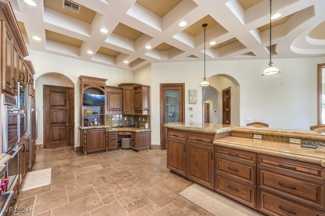 kitchen featuring tasteful backsplash, coffered ceiling, pendant lighting, beam ceiling, and oven