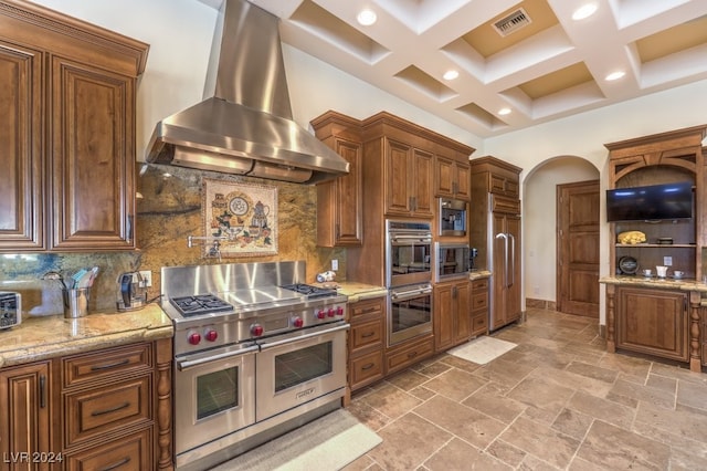 kitchen featuring decorative backsplash, coffered ceiling, wall chimney range hood, high quality appliances, and beamed ceiling