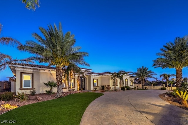 mediterranean / spanish-style home with a front lawn