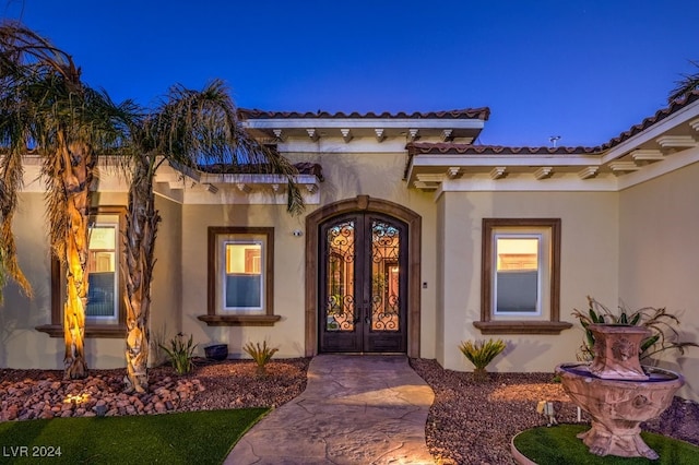 view of exterior entry featuring french doors