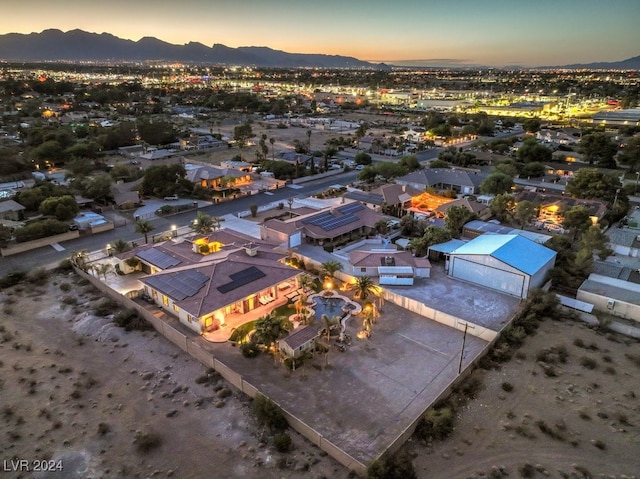 aerial view at dusk featuring a mountain view