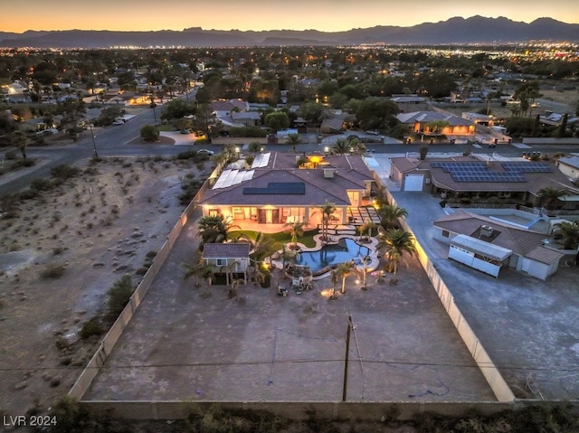 aerial view at dusk featuring a mountain view