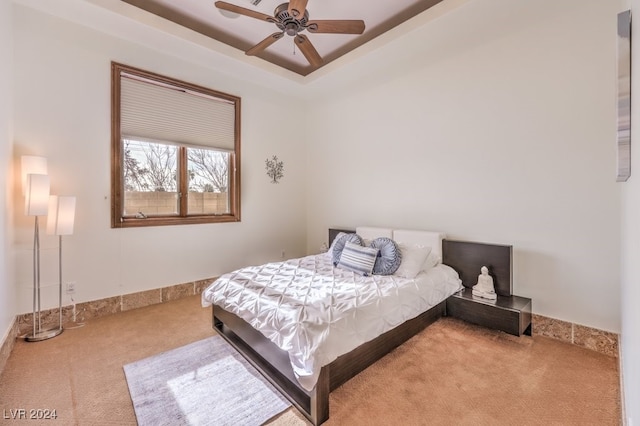 bedroom featuring ceiling fan and light carpet