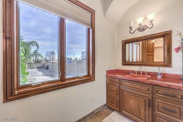 bathroom featuring a chandelier, vanity, and tile patterned floors