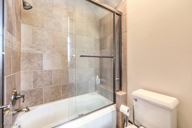 bathroom with shower / bath combination with glass door and toilet