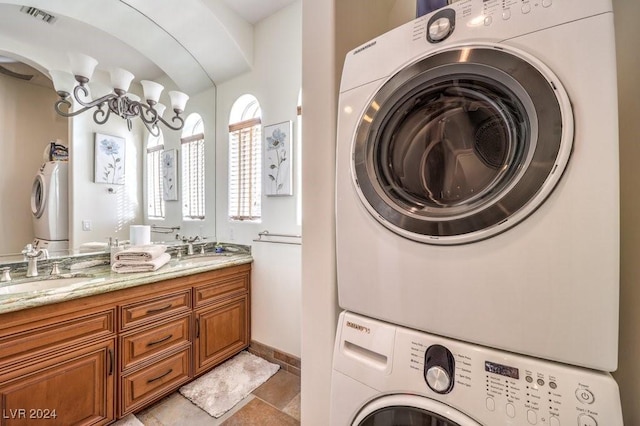 laundry area with stacked washing maching and dryer and sink