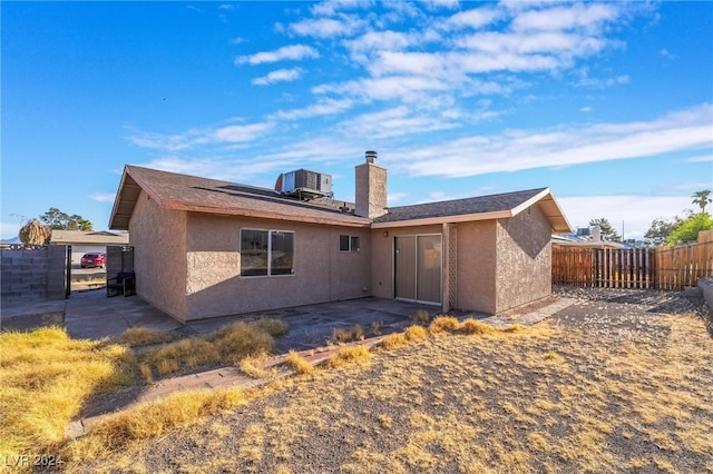 rear view of property featuring central AC unit and a patio area