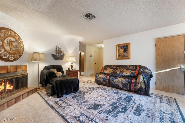 living room featuring a textured ceiling, a fireplace, and light carpet