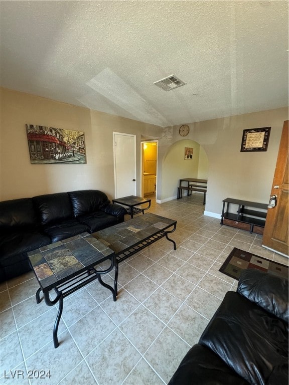 tiled living room with a textured ceiling