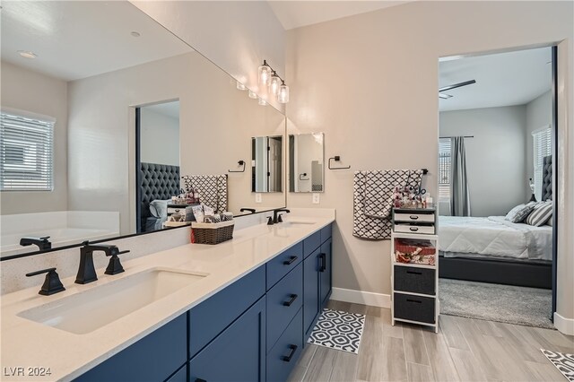 bathroom with vanity, hardwood / wood-style floors, and ceiling fan