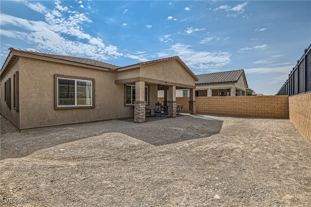 back of property featuring a patio area