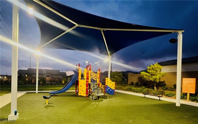 view of jungle gym featuring a lawn