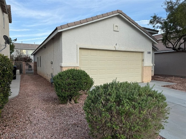 view of side of home with a garage