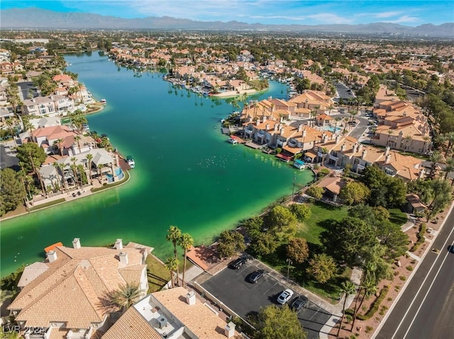 birds eye view of property with a water and mountain view