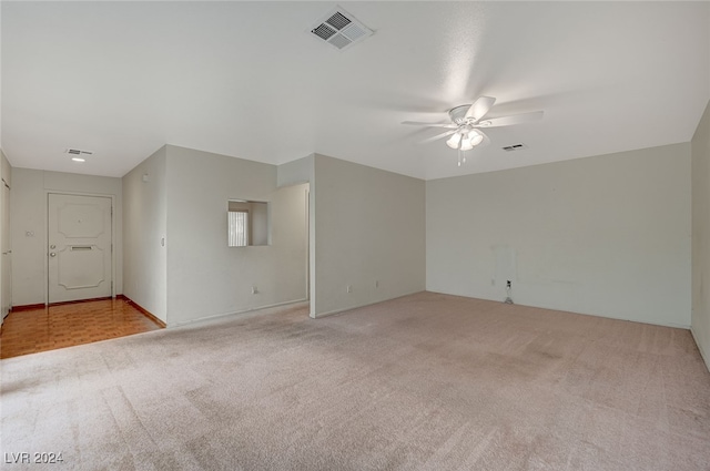 unfurnished room with light carpet and ceiling fan