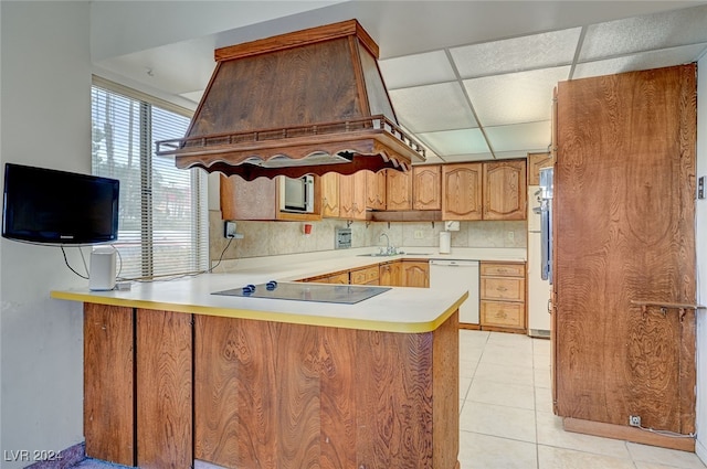 kitchen featuring white dishwasher, light tile patterned floors, kitchen peninsula, a paneled ceiling, and black electric cooktop