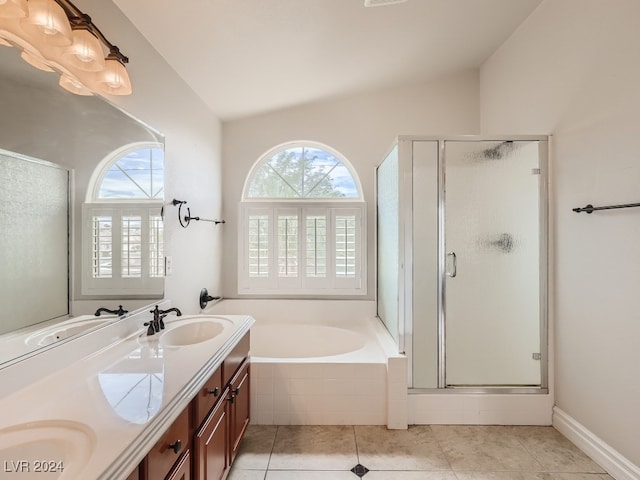 bathroom with tile patterned flooring, vaulted ceiling, vanity, and separate shower and tub