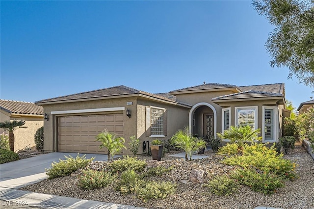 10315 Premia Pl, Las Vegas, NV 89135 - mediterranean / spanish-style home featuring a garage, stucco siding, and concrete driveway