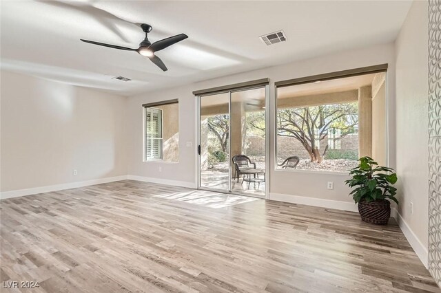 unfurnished room featuring hardwood / wood-style flooring and a wealth of natural light