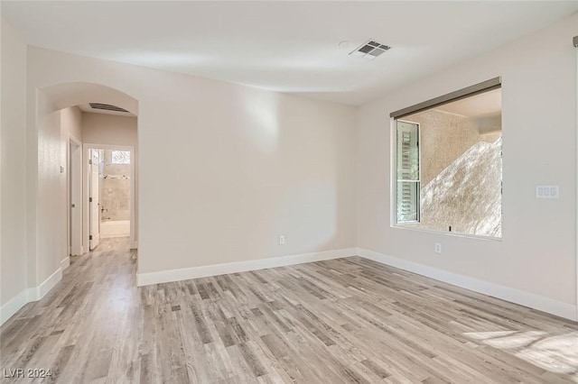10315 Premia Pl, Las Vegas, NV 89135 - empty room with arched walkways and light wood-type flooring