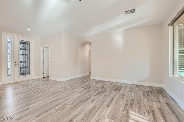 10315 Premia Pl, Las Vegas, NV 89135 - empty room featuring arched walkways, light wood-style flooring, and recessed lighting
