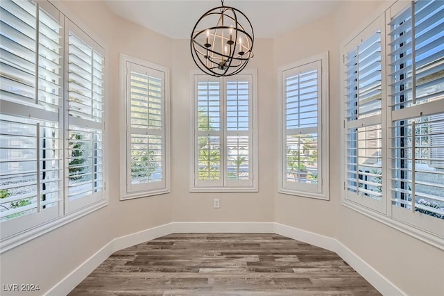 unfurnished sunroom featuring a chandelier